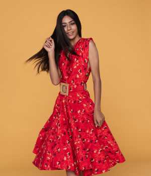 Model in thin red average-size yet lightweight dress with yellow pattern