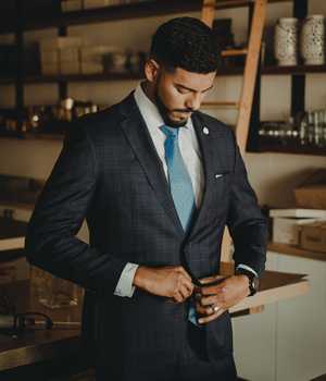 Model in darkgray suit with a hint of darkgray checkerboard pattern