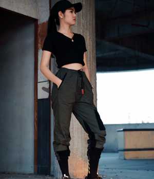 Model in darkgray pants with black stickers and pirate-like legs